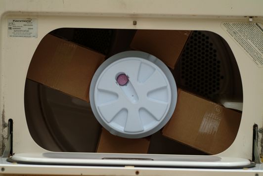 Tumbler barrel inside clothes dryer.