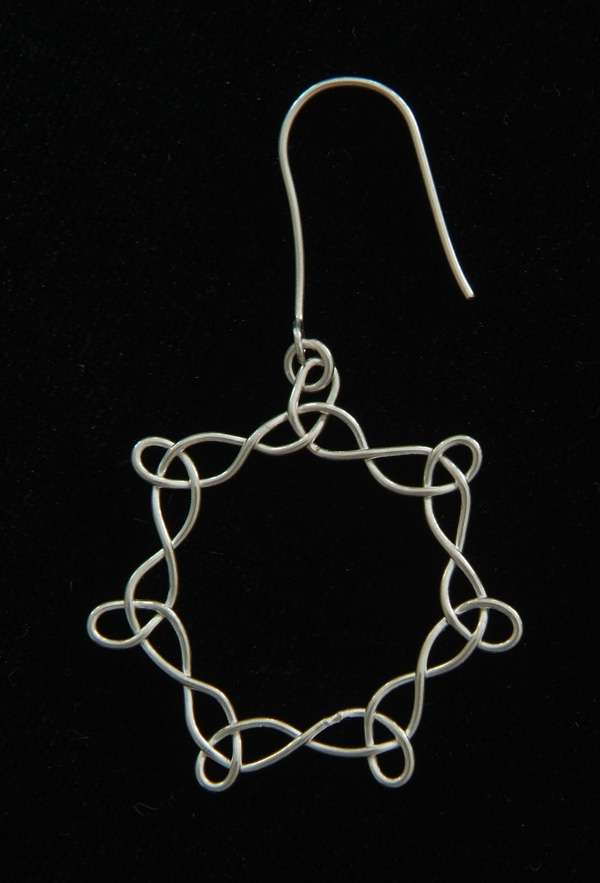 Celtic heptangle earring in fine silver.