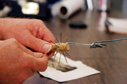 Tying a knot in wire.