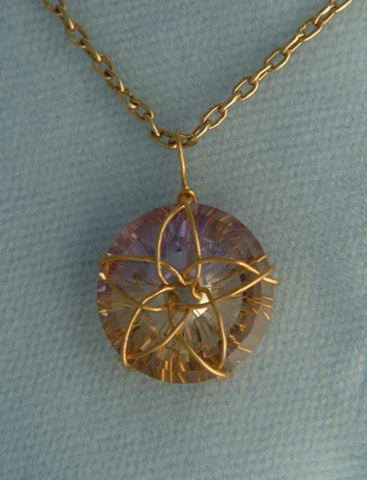 Ametrine with 24K gold Torus Knot setting.