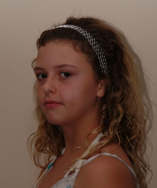 Silver hair band, or tiara, on a young model.