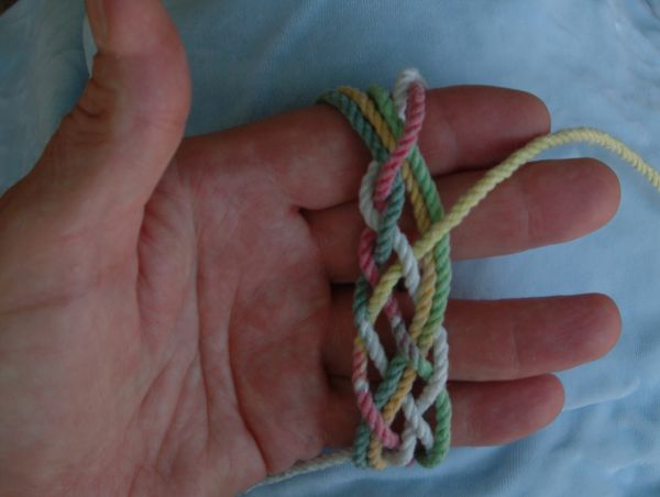 Tying a seven-lead nine-bight knot in hand.