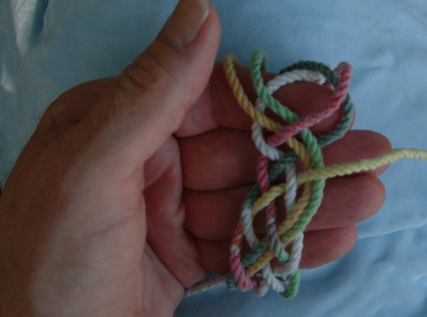 Tying a seven-lead nine-bight knot in hand.