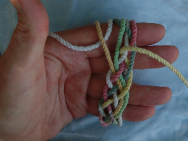 Tying a seven-lead nine-bight knot in hand.