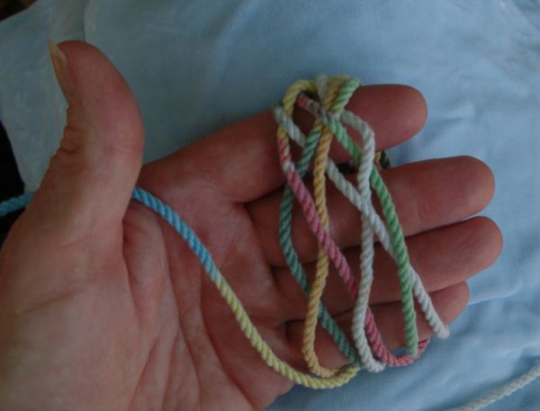 Tying a seven-lead nine-bight knot in hand.