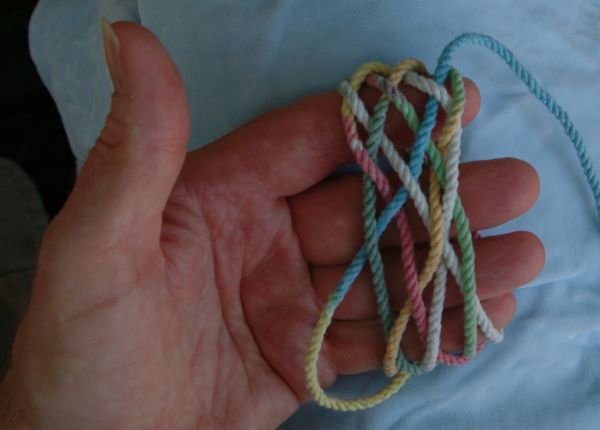 Tying a seven-lead nine-bight knot in hand.