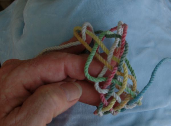 Tying a seven-lead nine-bight knot in hand.