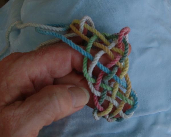 Tying a seven-lead nine-bight knot in hand.