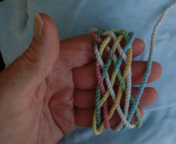 Tying a seven-lead nine-bight knot in hand.