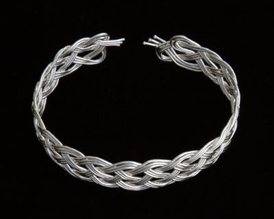Five part chain knot, nineteen loops, tripled, in fine silver.